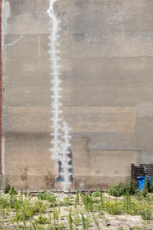 puttied crack in the wall of a tall house collapsing with an attempt to repairの写真素材