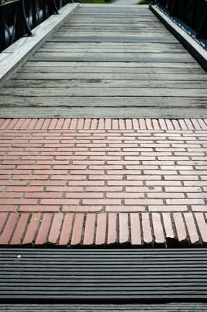 Pedestrian bridge made of red brick and wood.の写真素材