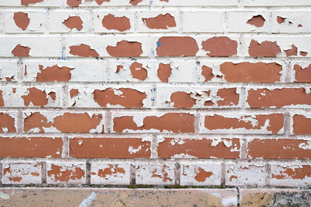 New red brick wall with peeling white paint. Abstract background. Place for text.の写真素材