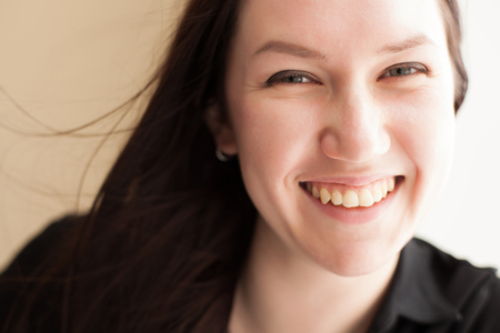 Pretty brunette girl with long hair  smiles の写真素材