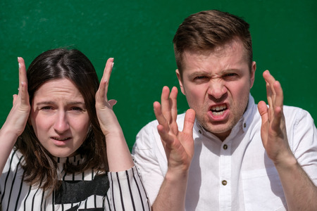 Young couple shouts. Shocking from what they saw, worrying about problemsの写真素材