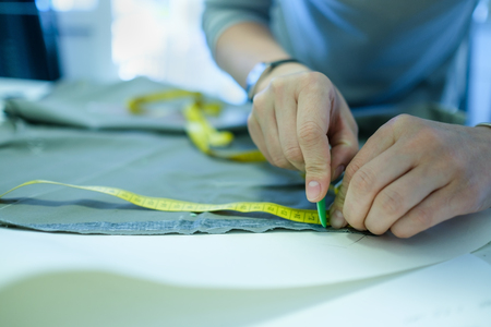 Closeup of skilled caucasian tailor working.の写真素材
