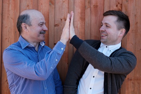 Father and son on wooden background
