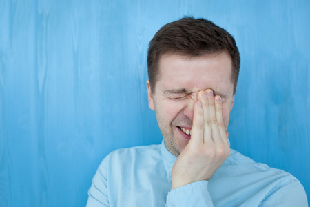 Caucasian man in blue shirt smiling happiness carefree emotional expression conceptの写真素材