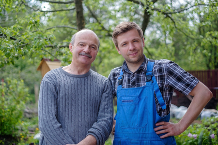 Two happy gardeners between green treesの写真素材