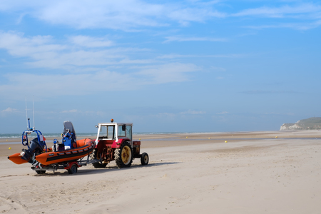 WISSANT, FRANCE - JULY 20 - Tractor woth rescue boat on sandy beachのeditorial素材