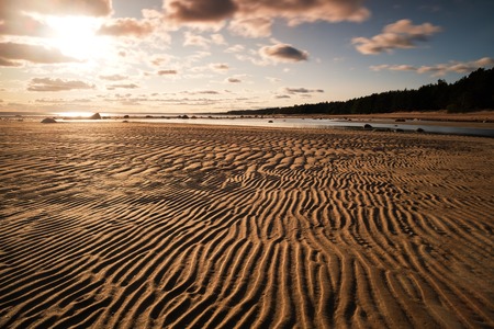 empty waved sand near lake in summer evening in Russiaの写真素材