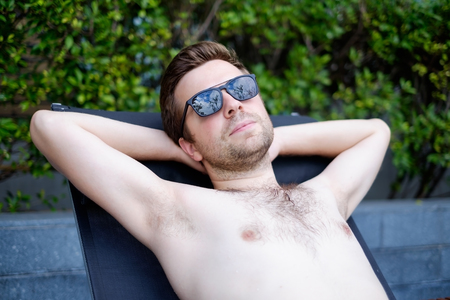 Content caucasian man in a swimming pool.