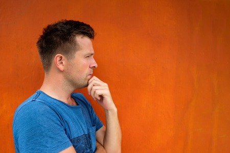 Side view portrait of thinking caucasian young man looking awayの写真素材