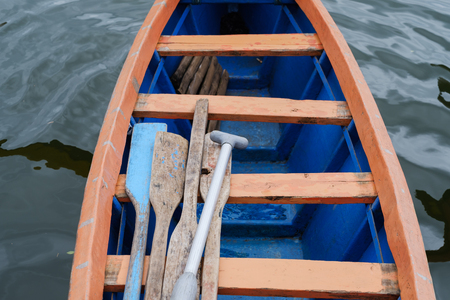 Detail of blue boat witn paddles inside.