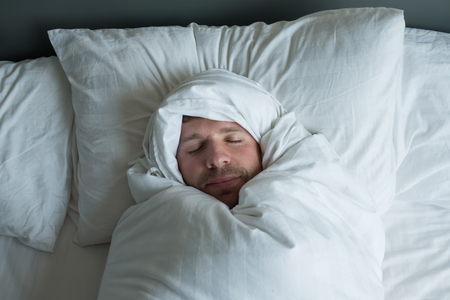 caucasian man napping with happy face expression.