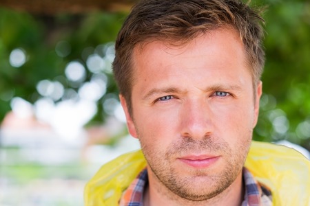 Close up portrait of serious smiling middle aged man face