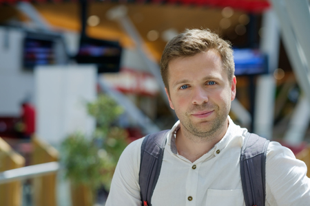 Portrait of smiling caucasian man on blurred city background