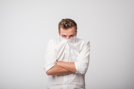 Shy older man hiding behind his turtleneck sweaterの素材 [FY310102968608]