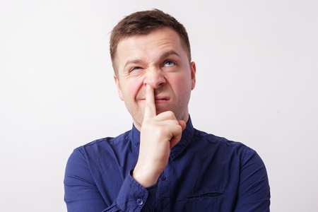 studio portrait caucasian man finger in noseの写真素材