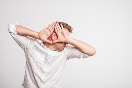 Caucasian man having hearing problem listening to somethingの写真素材