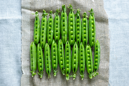 Fresh green peas in a line.