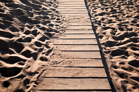 Detail view of a wooden beach path with some sand on itの写真素材