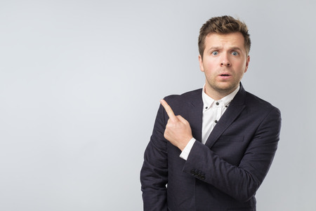 portrait of a young business man pointing on important informationの写真素材