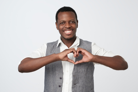 African black man making out of hands heart. Doing charity workの写真素材