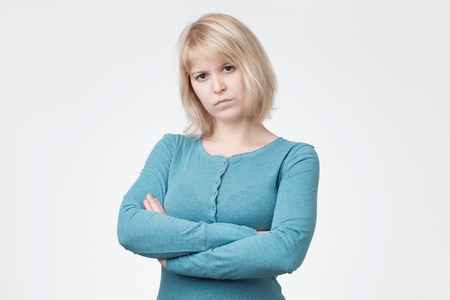 Portrait of sad or serious young woman in studioの写真素材