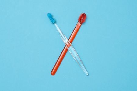 Two used color toothbrush on blue backgroundの写真素材