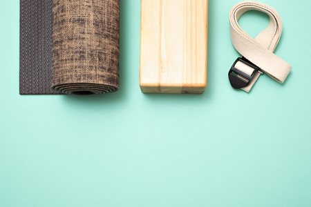 Top view of yoga accessories: rolled exercise mat, block and belt.の写真素材