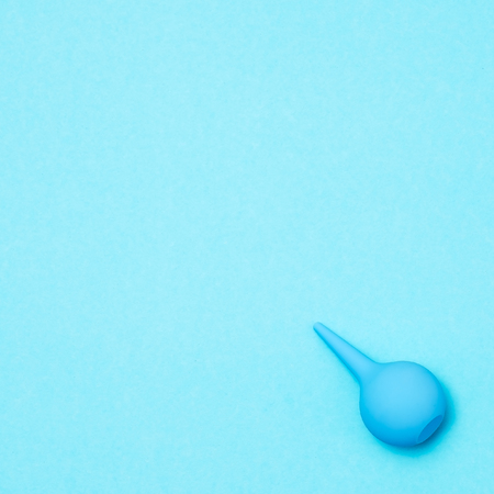 Blue enema on a colored background. flat lay viewの写真素材