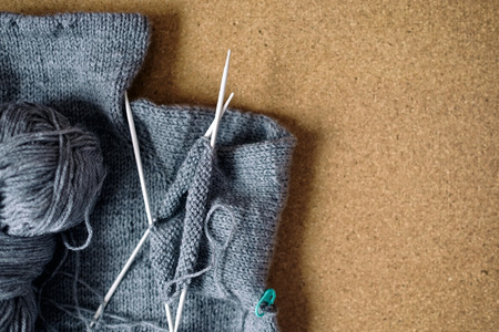 Incomplete knitting gray sweater for child with needles
