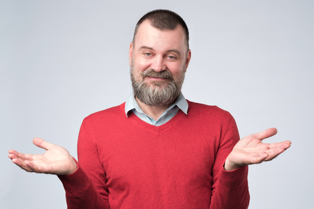 man showing I have no idea gesture, shrugging shoulders and raising handsの写真素材