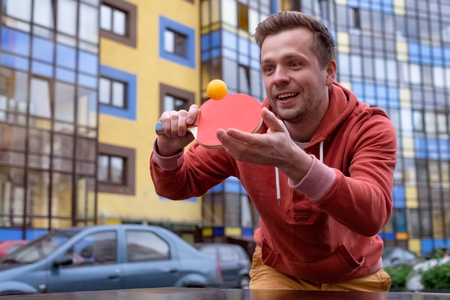Young caucasian man playing table tennis, ping-pongの写真素材