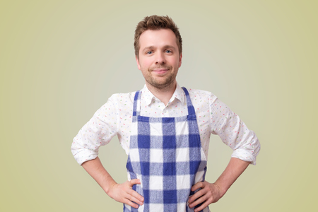 mature restaurant employee man on yellow wallの写真素材