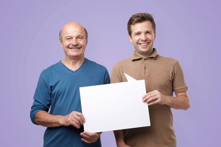 two men showing empty copyspace for ad.