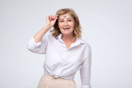 Portrait of business woman smiling and holding glassesの写真素材
