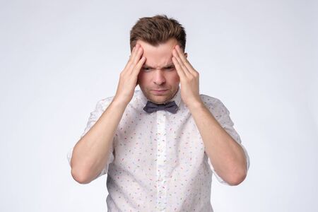 Have some troubles. Young caucasian man with headacheの写真素材