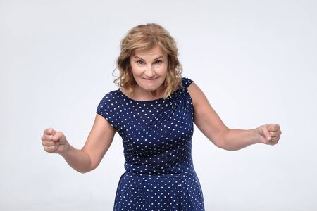 Mad, angry, upset mature woman pissed off screaming threatening you