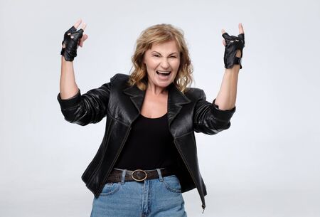 Crazy beautiful rock mature woman in leather jacket.の写真素材
