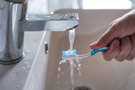 Toothbrush washing under water in the morning Close up viewの写真素材