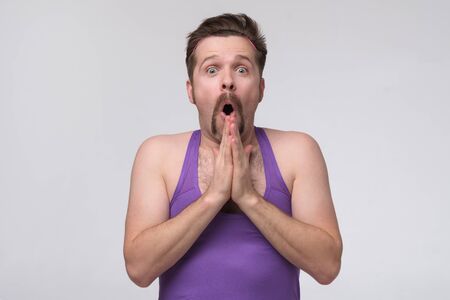 Young fitness man wearing casual sports sweatshirt shocked with surprise expressionの写真素材
