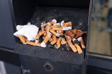 A lot of cigarette butts close up view. Bad habbit for healthの写真素材