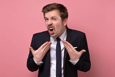 man with funny mustache looking with doubt and suspicion making excusesの写真素材