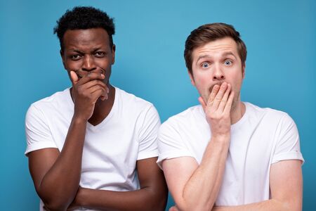 Two shocked men look with amazement at camera, cant believe in failure, stand next to each other....