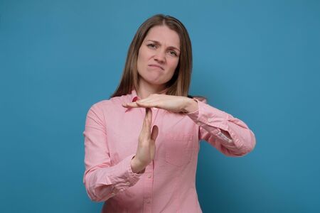 Young caucasian woman showing a timeout gesture