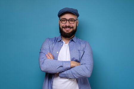 Young man with glasses and beard smilingの写真素材