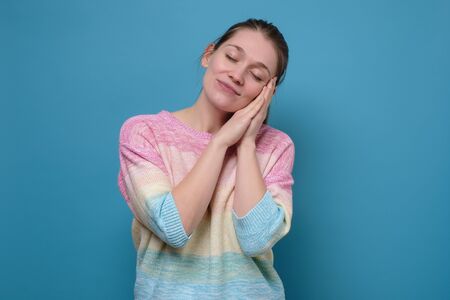 Sleepy caucasian young woman with closed eyes.の写真素材
