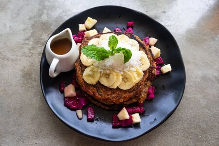 Delicious pancakes with bananas on black plateの写真素材