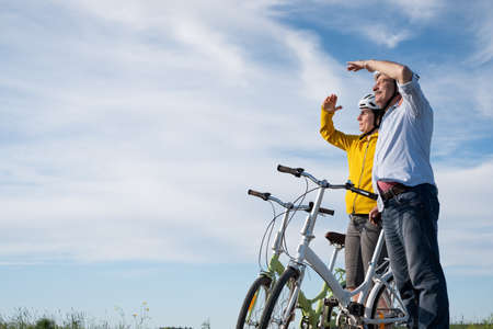 Happy father and daughter cycling outdoors and leading a healthy lifestyle.