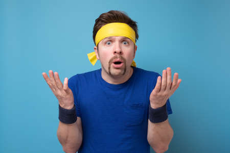 Young caucasian sport man confused and doubtful shrugging shoulders.の写真素材