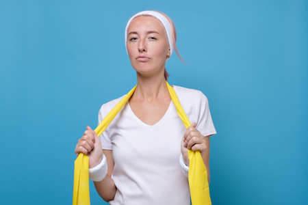 Young caucasian woman is tired after exercing at gymの写真素材