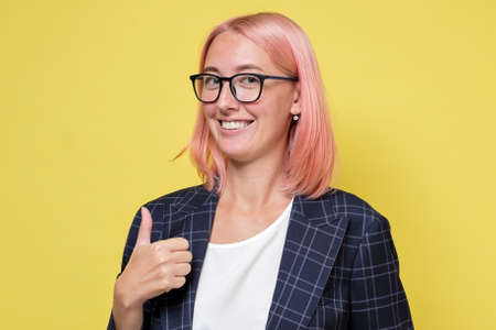 Happy smiling woman with thumbs up gestureの写真素材